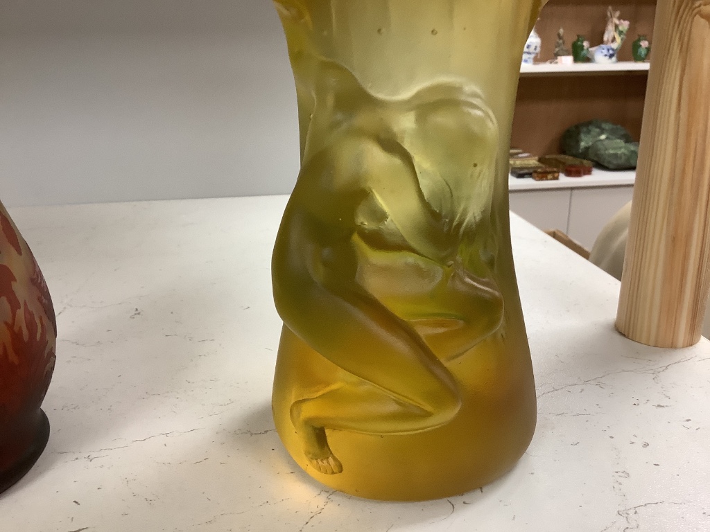 An amber vase with a nude study in relief, apocryphal Daum mark, 24cm high